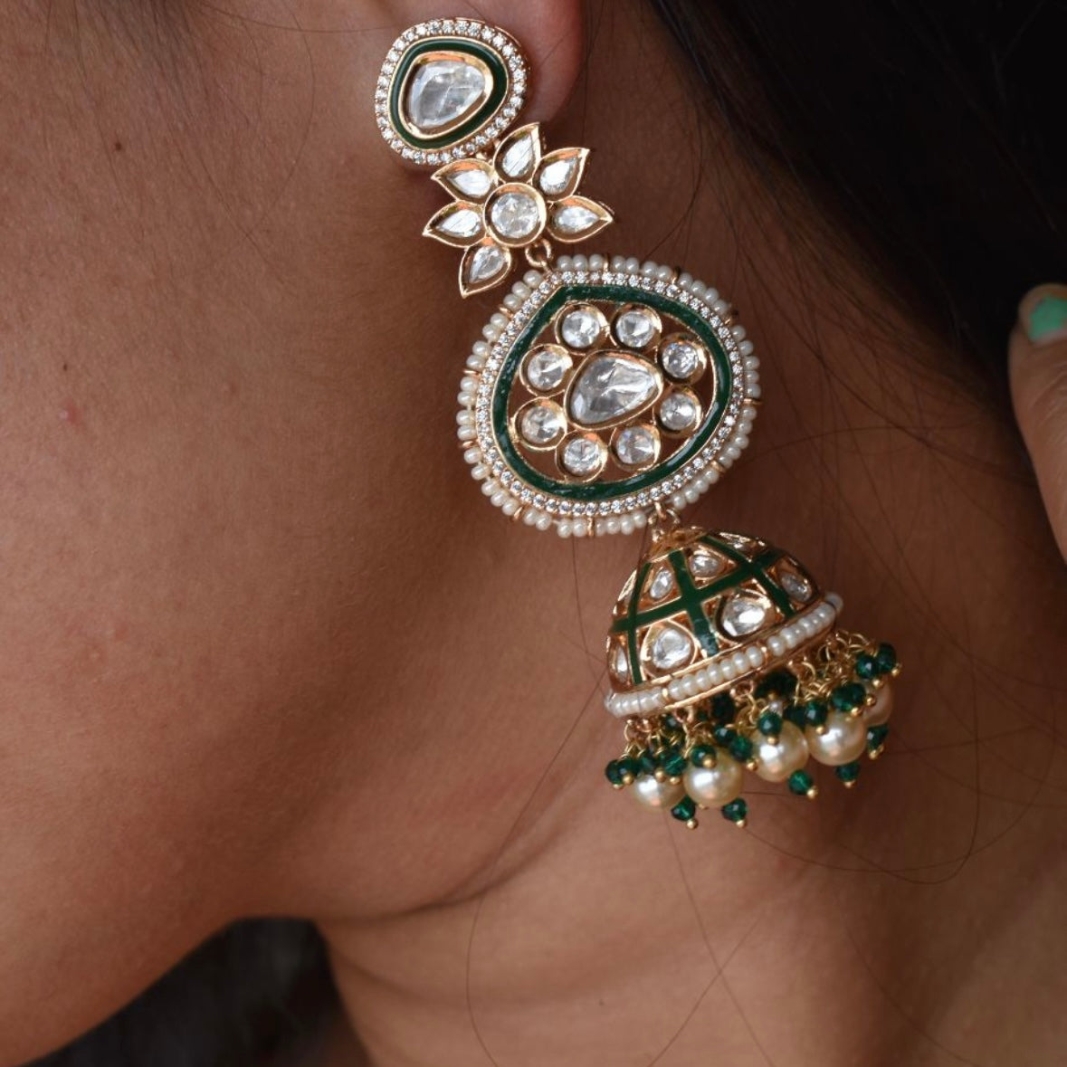 Green enamel jhumka earrings with polki-style stones and pearl clusters in front view