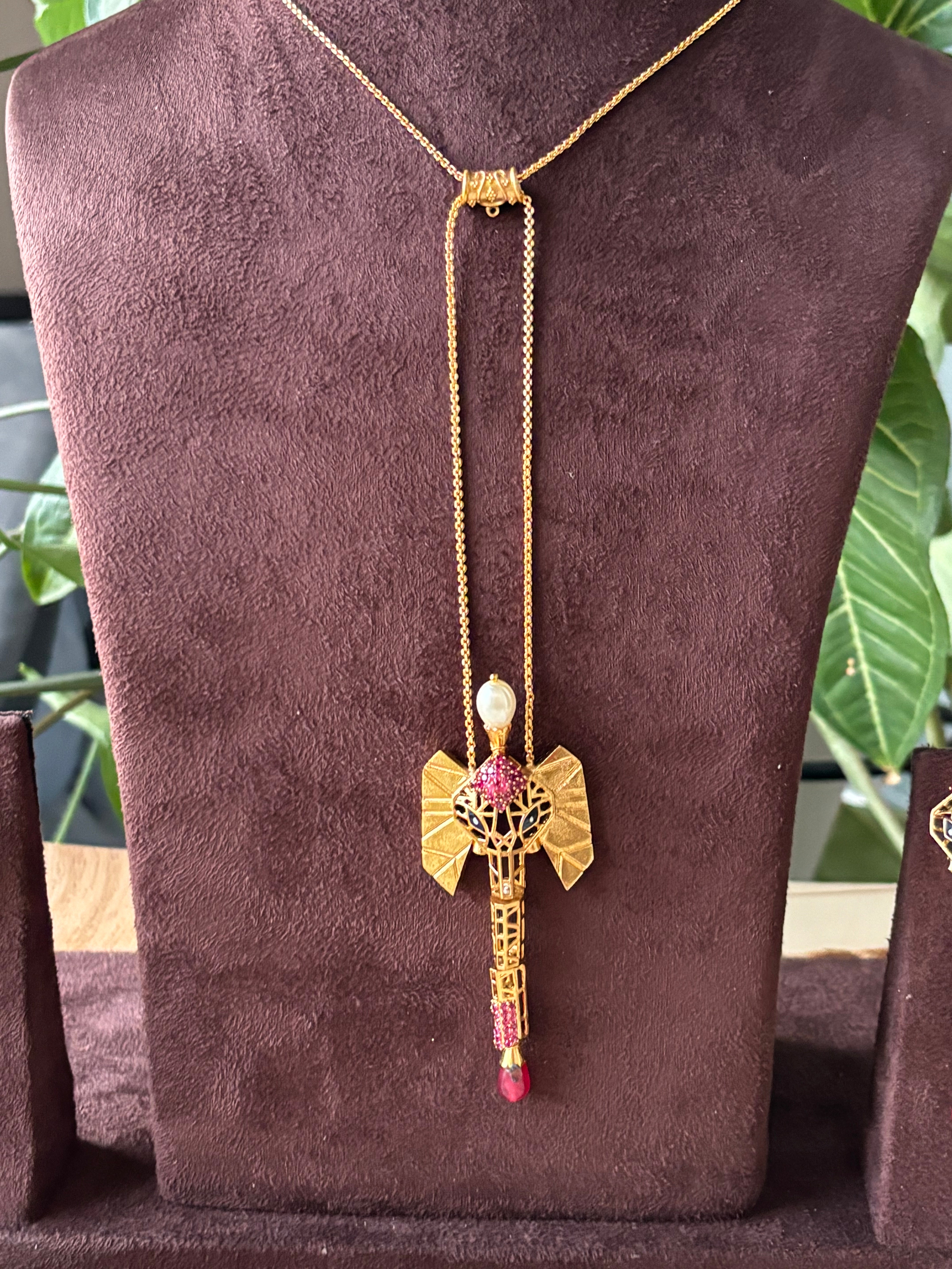 Front view of Indo-western gold plated pendant with earrings