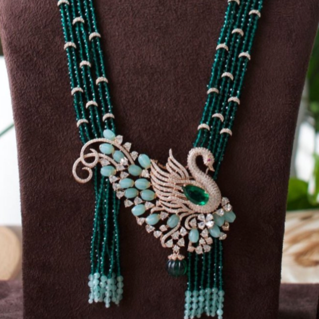 angled image of gemstone beaded peacock necklace set in a premium finish